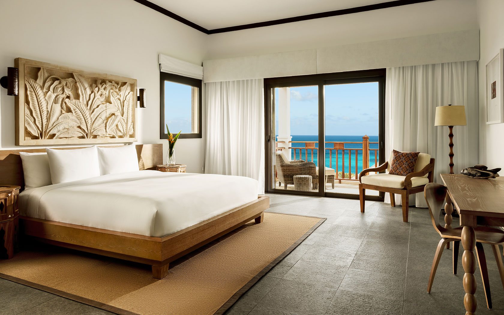 King bed, side table, view of balcony to ocean