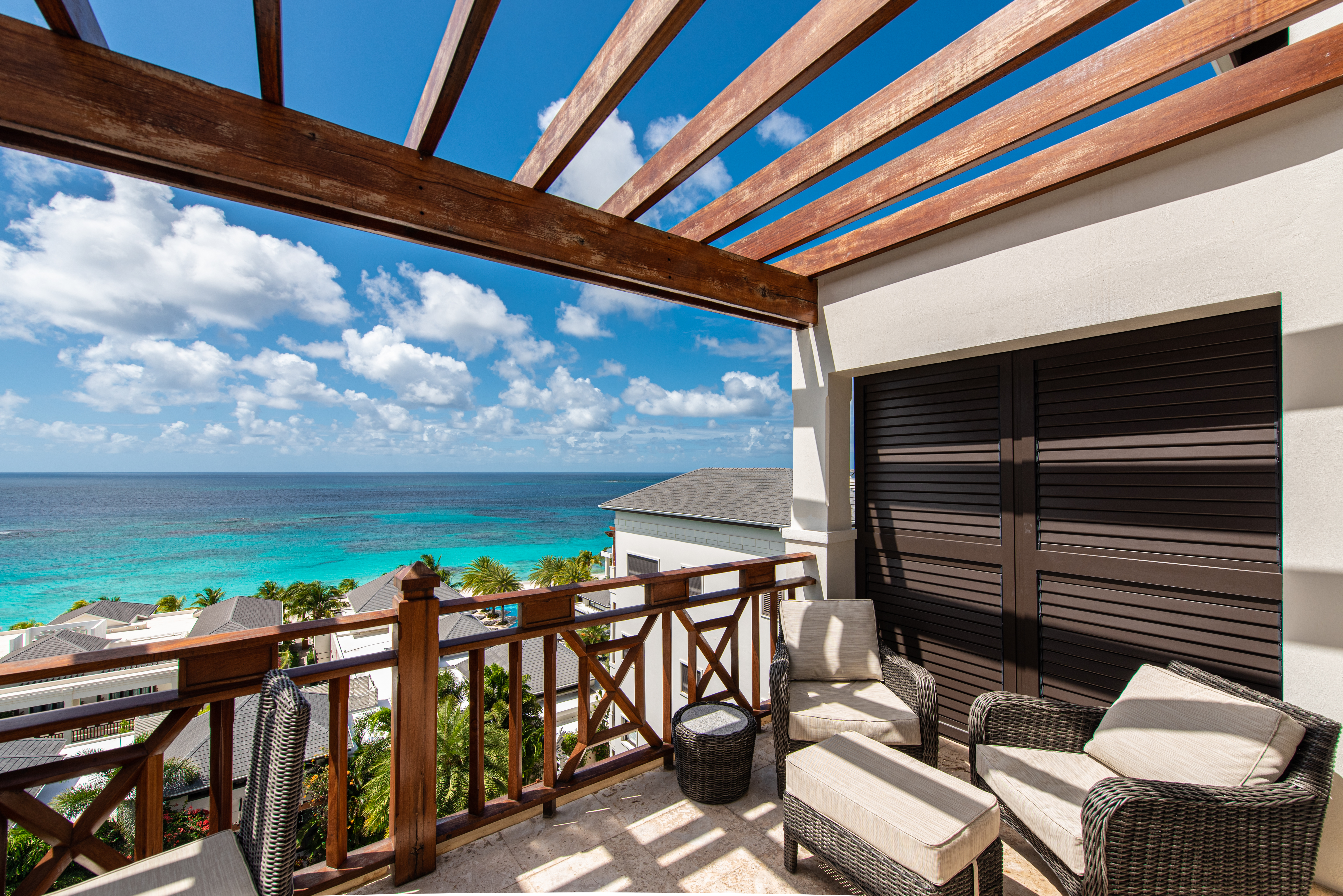 Outdoor balcony with lounge chairs and view of ocean