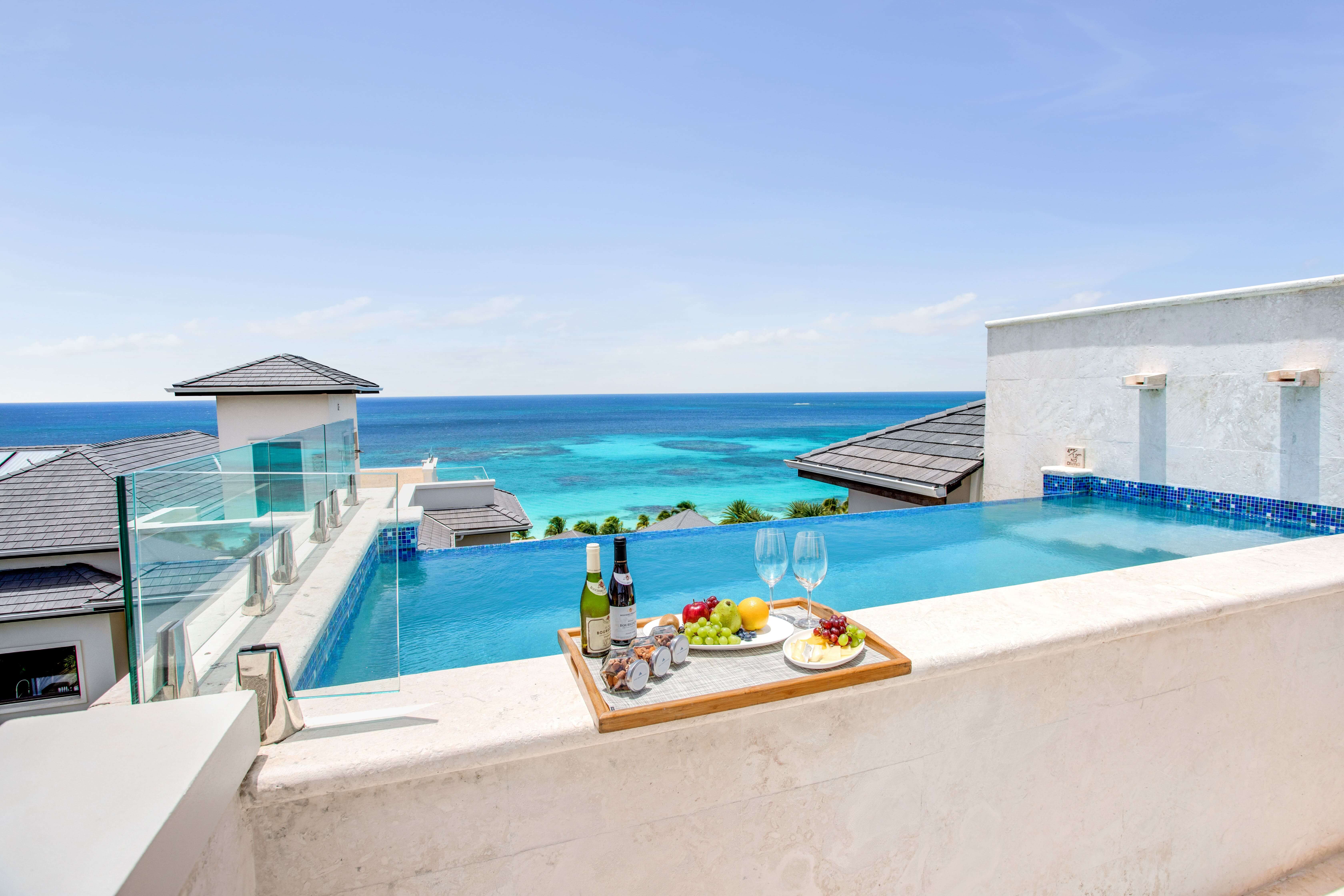 Pool with tray of drinks on edge with view of pool
