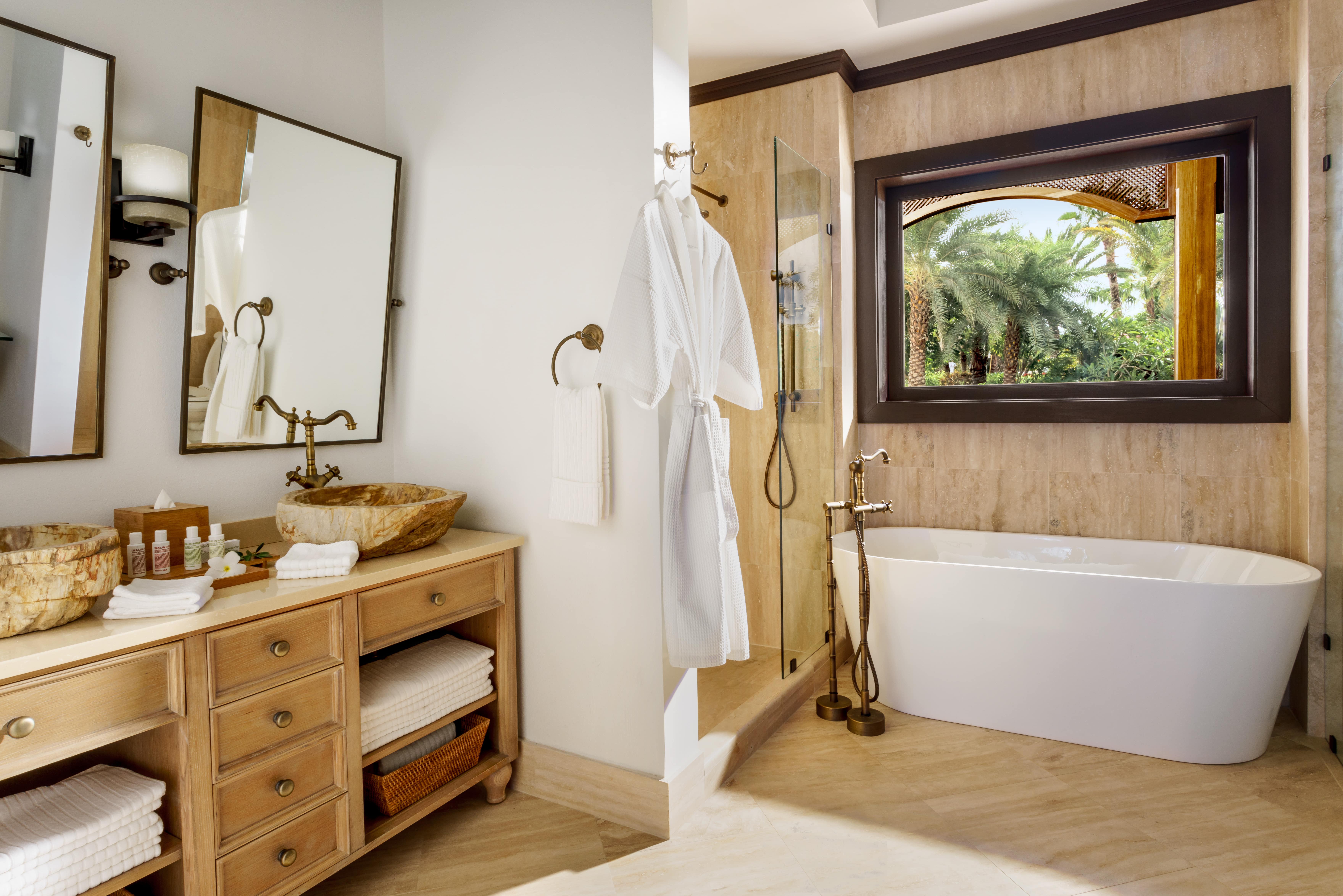 Soaker bathtub, shower, brown vanity and mirror